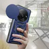 A hand holding a blue phone case with a ring holder and camera cover, with a blurred background of an indoor setting. Produktbild-Vorschau