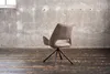 A single chair in an industrial-style room with a concrete wall and wooden floor. Produktbild-Vorschau