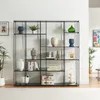A modern black metal shelving unit filled with decorative items and books, set against a white wall. Náhled obrázku produktu