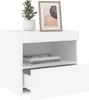 A white nightstand with an open drawer, a shelf with books, and a framed picture and plant on top. Produktbild-Vorschau