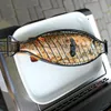 A whole fish is being grilled in a fish-shaped grill basket, which is placed on a white rectangular dish. The dish is on top of a grill. Produktbild-Vorschau