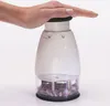 A hand is pressing down on the top of a manual food chopper filled with chopped red onions. Produktbild-Vorschau