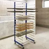 A drying rack with several shelves holding various wooden panels and frames, likely in a workshop or storage area. Anteprima dell’immagine prodotto