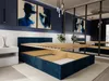 A bedroom with a dark blue upholstered bed frame with the mattress support raised, revealing storage space underneath. Two abstract blue paintings hang on the wall above the bed. Produktbild-Vorschau