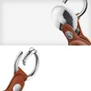 A close-up of an Apple AirTag attached to a brown leather keychain. Produktbild-Vorschau