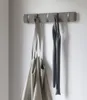 A wall-mounted coat rack with two items hanging on it. Náhľad obrázku produktu