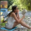 A woman is reading a book by a river, with three inset images showing hiking, a stadium, and gardening. Produktbild-Vorschau