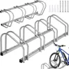 A product shot of a bicycle rack with a bicycle in the foreground. Náhled obrázku produktu