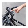 A hand is shown interacting with a smartphone mounted on a bicycle handlebar. Voir les images du produit