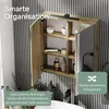 A bathroom cabinet with its doors open, displaying shelves with toiletries and decorative items. The background features a striped wall. Produktbild-Vorschau