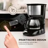A close-up of a coffee maker with a hand pressing a button on its control panel, and text overlays highlighting features. Produktbild-Vorschau