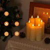 A Christmas tree and a stack of LED candles are displayed on a table. Voir les images du produit