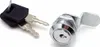 A product shot of two keys and a lock cylinder on a white background. Náhled obrázku produktu