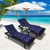 Two navy blue chaise lounge cushions are set up on a sandy beach with palm trees and the ocean in the background, under a white umbrella. Náhled obrázku produktu