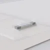 A close-up, slightly angled view of a white nightstand with a silver handle. Produktbild-Vorschau