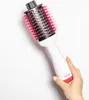 A hand holding a white and pink hair dryer brush against a white background. Anteprima dell’immagine prodotto