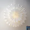 A white paper star lantern hanging against a light-colored wall. Podgląd zdjęcia produktu