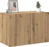 A wooden cabinet with two doors, decorated with a framed picture and a small plant. Voir les images du produit