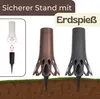 The image shows two decorative vases with ground spikes, one in bronze and one in gray, inserted into the ground. An inset shows a white vase and a black spike being assembled. Produktbild-Vorschau