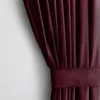 A close-up view of a burgundy velvet curtain with pleats and a tie-back. Produktbild-Vorschau