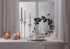 A table setting with candles and wine glasses, likely for a festive occasion. Produktbild-Vorschau