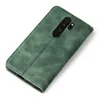 A green flip cover for a smartphone, shown from the back with the camera module visible. Produktbild-Vorschau