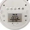 The back of a white digital alarm clock, showing buttons, a speaker grille, and a battery compartment label. Náhled obrázku produktu
