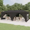 An outdoor party tent set up on a patio with tables and chairs inside. Produktbild-Vorschau