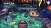 A cluttered desk with various objects, including books, a typewriter, and electronic devices, in a dimly lit room. Produktbild-Vorschau