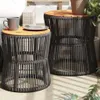 Two outdoor side tables with wooden tops and woven bases are shown on a patio. Náhled obrázku produktu