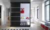 A modern bedroom or living room with a large black wardrobe with mirrored doors. Náhled obrázku produktu