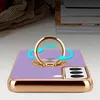 A close-up shot of a purple phone case with a gold ring holder, placed on a light-colored surface. Produktbild-Vorschau