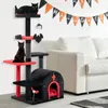 A Halloween-themed cat tree with two black cats, set against a white wall with a Halloween banner and a white sofa. Produktbild-Vorschau