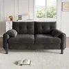 A dark gray sofa is shown in a well-lit room with a window in the background. Produktbild-Vorschau