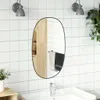 A bathroom scene with a mirror over a sink. Podgląd zdjęcia produktu
