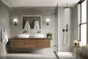 A modern bathroom with a double vanity, a walk-in shower with a rain showerhead, and a window. The overall aesthetic is minimalist and luxurious. Produktbild-Vorschau