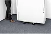 A person is moving a white cabinet on wheels across a gray carpeted floor. Anteprima dell’immagine prodotto