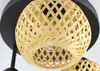Close-up of a woven bamboo lampshade attached to a black ceiling fixture. Náhled obrázku produktu