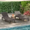 Two brown plastic sun loungers are set up on a patio next to a swimming pool, with an umbrella providing shade. There is a small table with oranges and drinks between the loungers. Podgląd zdjęcia produktu