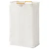 A white laundry basket with wooden handles against a white background. Produktbild-Vorschau