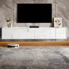 A modern living room with a wall-mounted TV and a sleek white TV stand. Anteprima dell’immagine prodotto