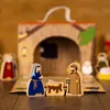 A wooden nativity scene with figures of Mary, Joseph, and baby Jesus in a manger, set against a backdrop of a stable. Produktbild-Vorschau