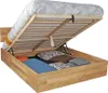 A wooden bed frame with the mattress lifted, revealing storage space underneath, filled with pillows. Produktbild-Vorschau