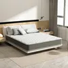 A mattress on a bed in a bedroom setting. Voir les images du produit