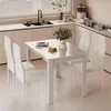 A modern kitchen with a white dining set in the foreground. Produktbild-Vorschau