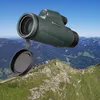 A monocular is shown in the foreground, with a group of hikers on a mountain ridge in the background. Produktbild-Vorschau
