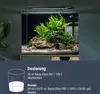 A close-up of an aquarium with plants and rocks, with dosage instructions below. Produktbild-Vorschau