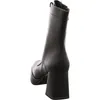 A black leather boot with a platform and block heel, shown from the back. Produktbild-Vorschau