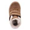 A top-down view of a brown child's boot with white soles and fuzzy lining. Podgląd zdjęcia produktu