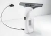 A white and gray Kärcher WV 1 electric window cleaner is shown plugged into a wall outlet with its charger. Voir les images du produit